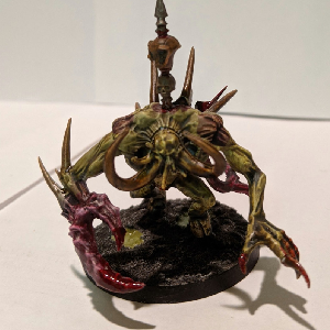 A photo of a green and pink tusked chaos spawn.