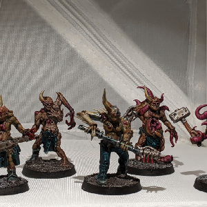 A photo of five pox walkers from the front. They are all wearing ragged clothing and wielding makeshift melee weapons.