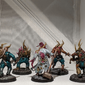 A photo of five pox walkers from the back. They are all wearing ragged clothing and wielding makeshift melee weapons.